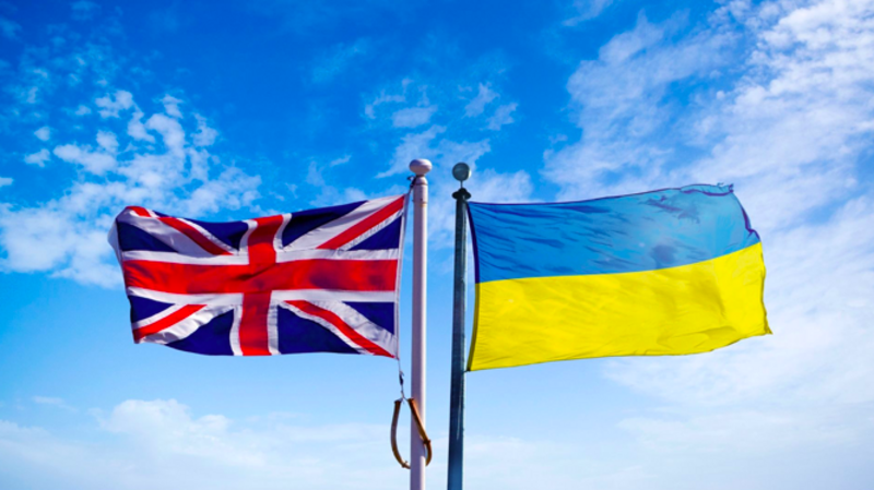 On the left, the flag of the United Kingdom, and on the right the flag of Ukraine. both in the sky